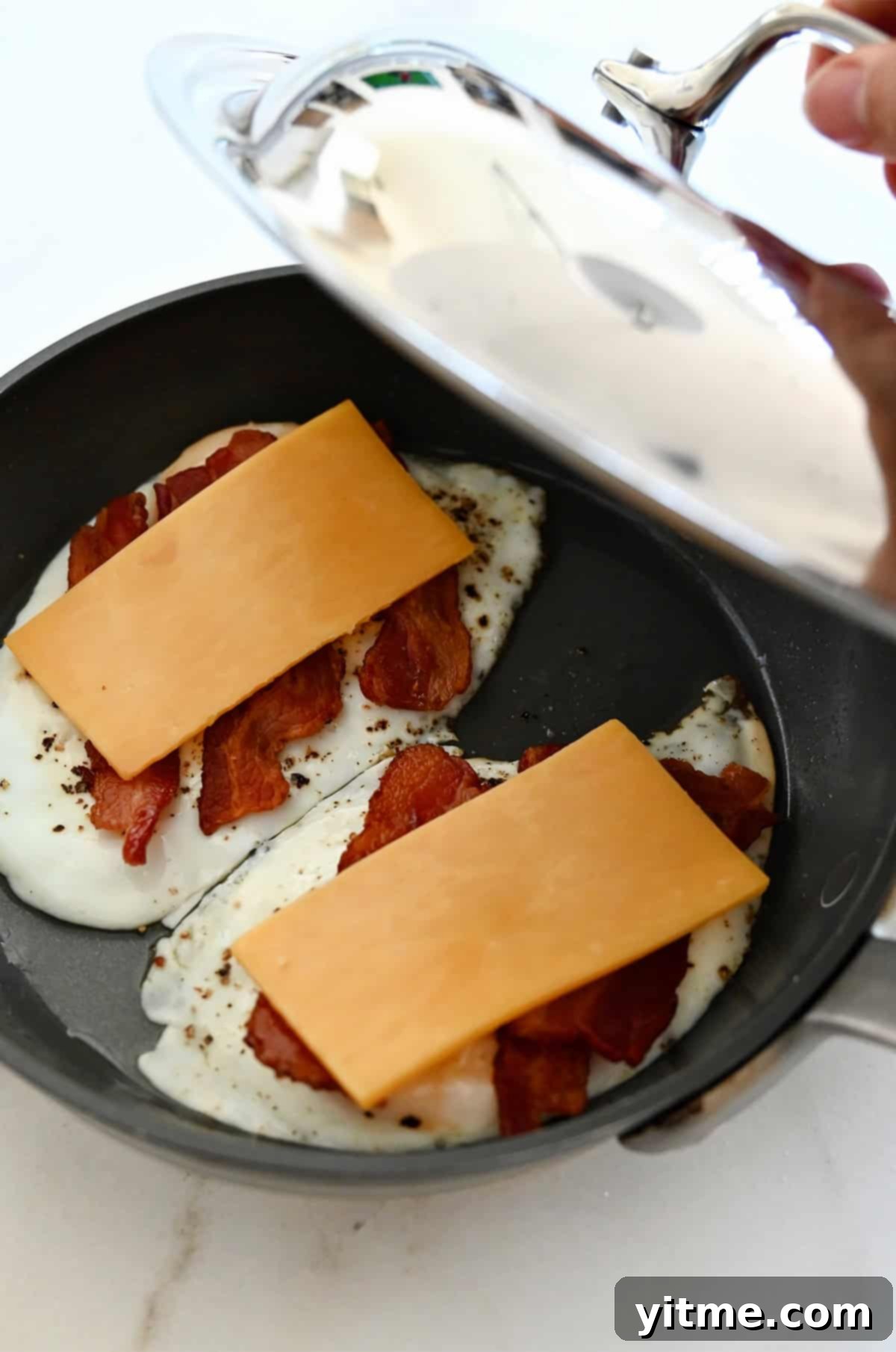 The Quintessential Egg Sandwich 5 Adding cheese to the eggs and bacon