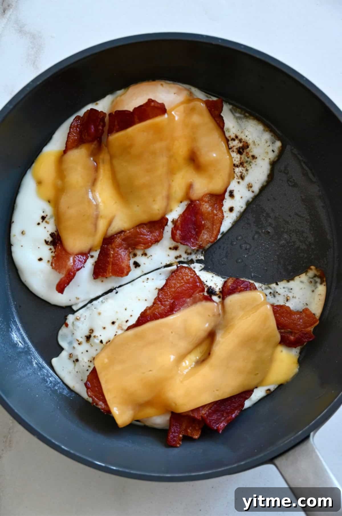The Quintessential Egg Sandwich 6 Melted cheese on eggs and bacon