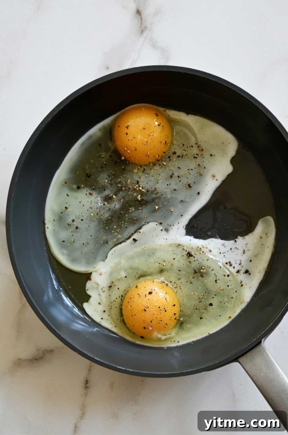 The Quintessential Egg Sandwich 8 Frying an egg in a non-stick skillet