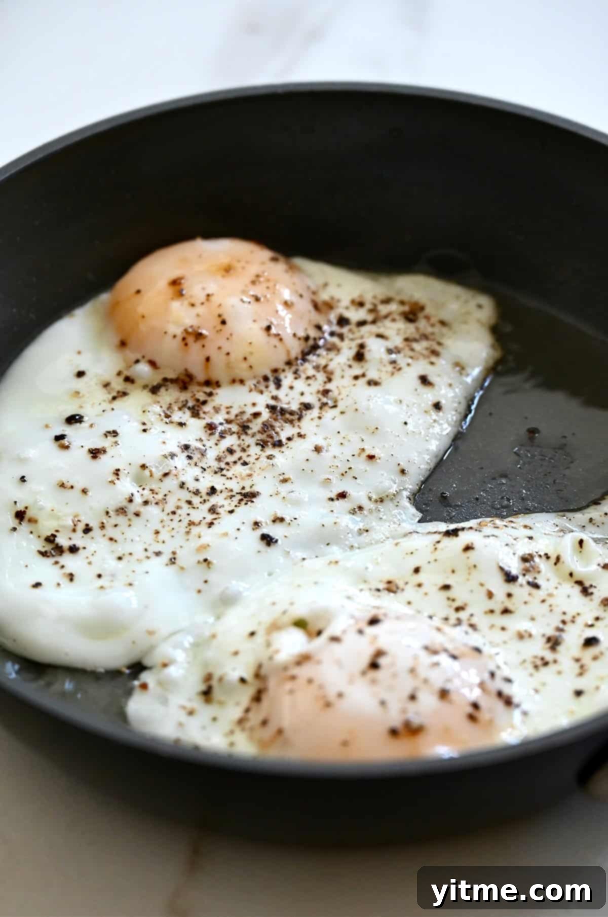 The Quintessential Egg Sandwich 9 Over-easy eggs in a skillet