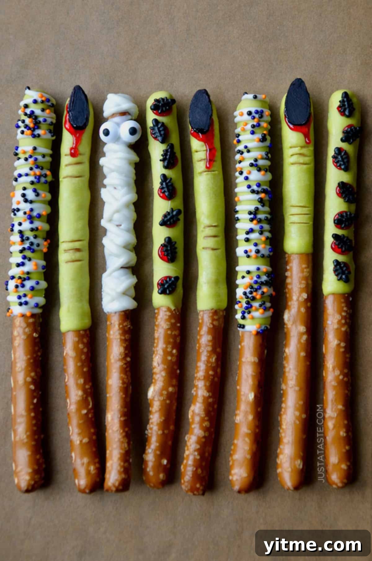 Spooky Halloween pretzel rods dipped in chocolate and decorated with festive sprinkles.