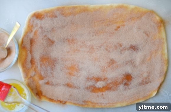 Pizza dough topped with cinnamon butter and sugar