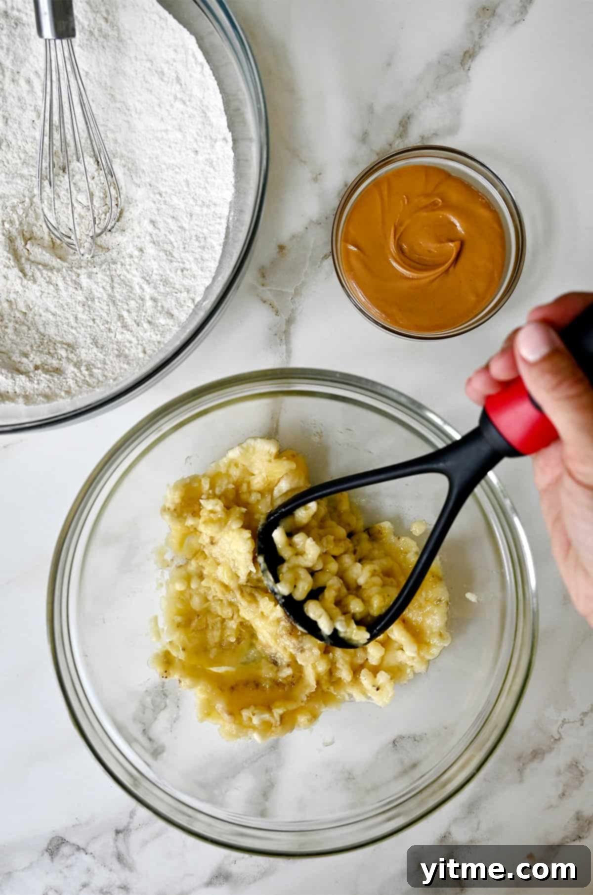 Peanut Butter Banana Bliss Bread 4 Mashing bananas with a potato masher