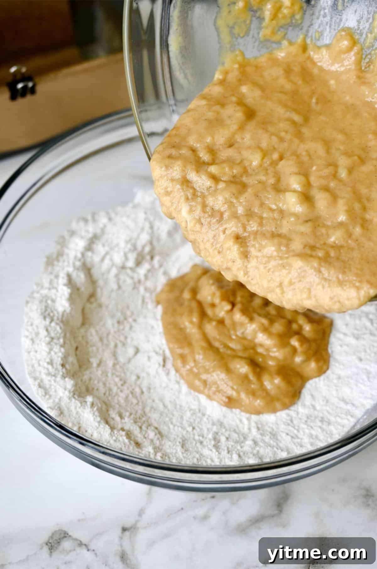 Peanut Butter Banana Bliss Bread 7 Pouring wet ingredients into dry ingredients