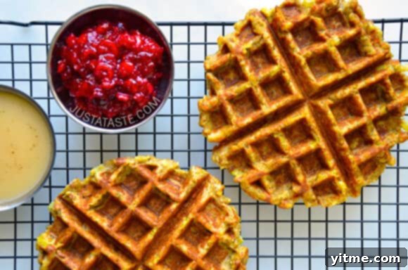 Two golden-brown stuffing waffles with savory toppings.