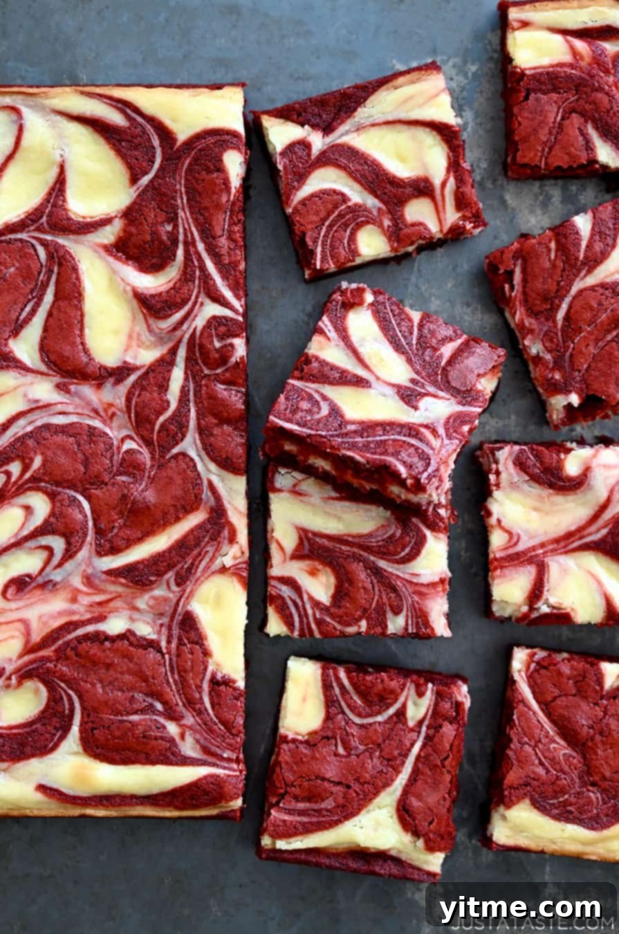 The best Red Velvet Cheesecake Brownies, perfectly sliced into squares, showcasing their creamy and fudgy texture.