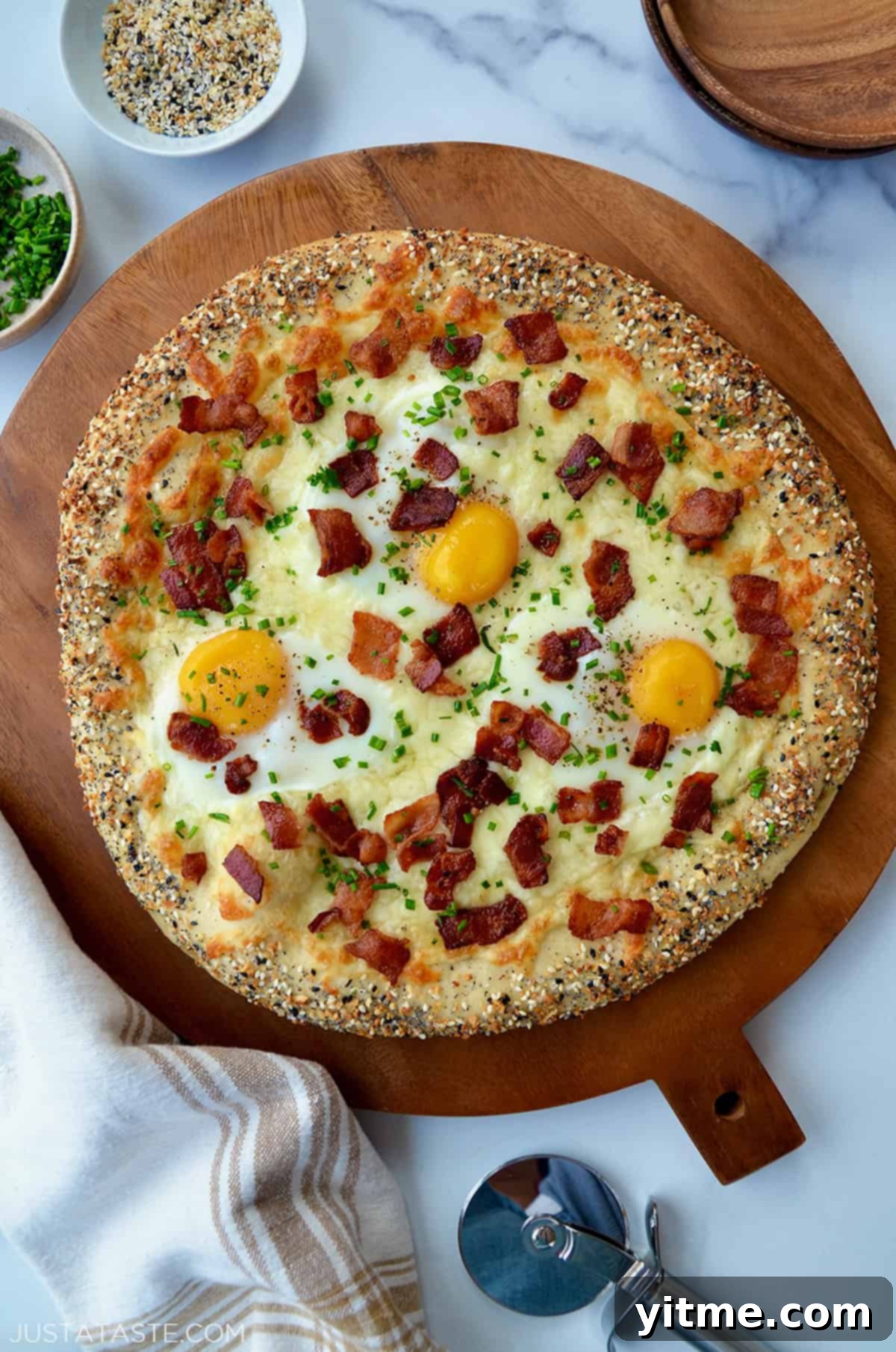 Breakfast pizza with eggs, bacon, and everything bagel seasoning