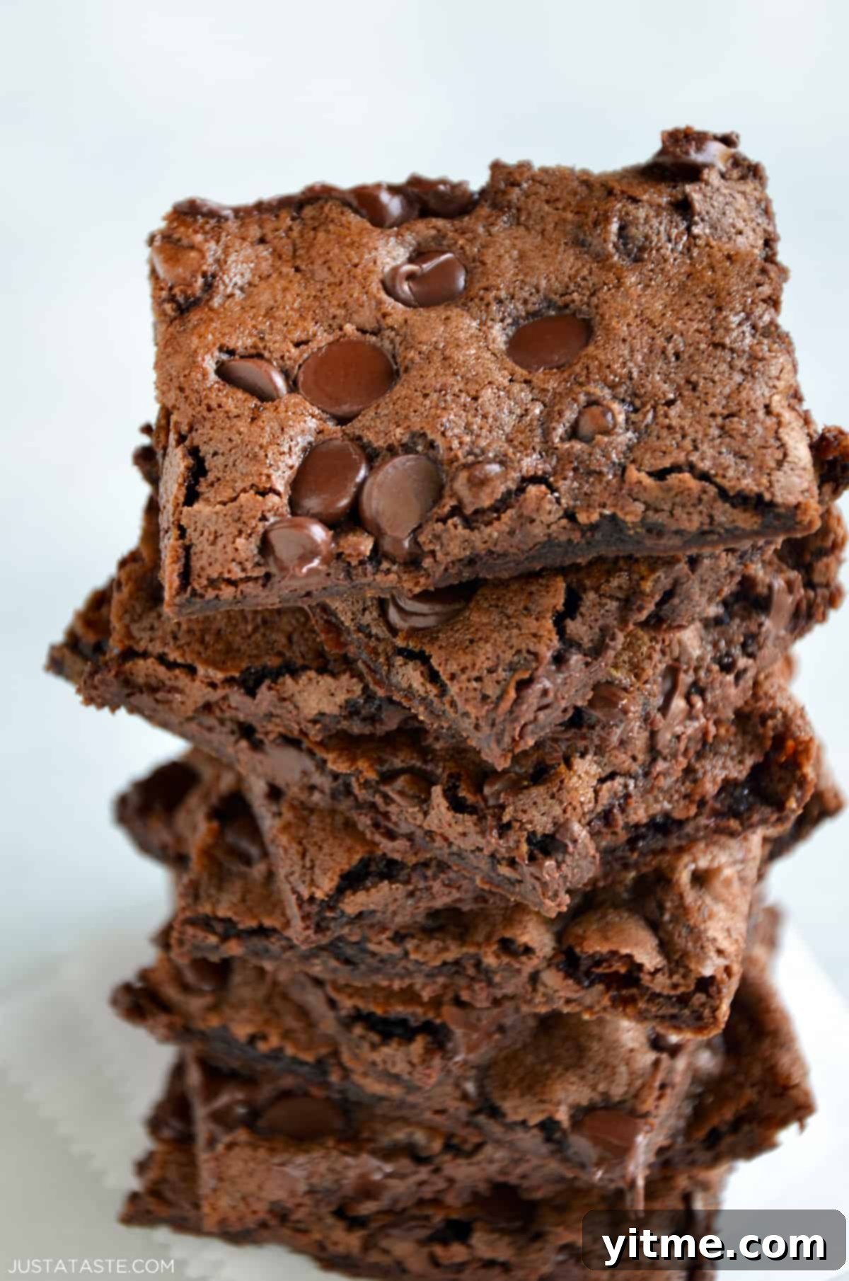 A tempting pile of chocolate chip-studded brownie bark, showcasing its irresistibly crispy and chewy texture.