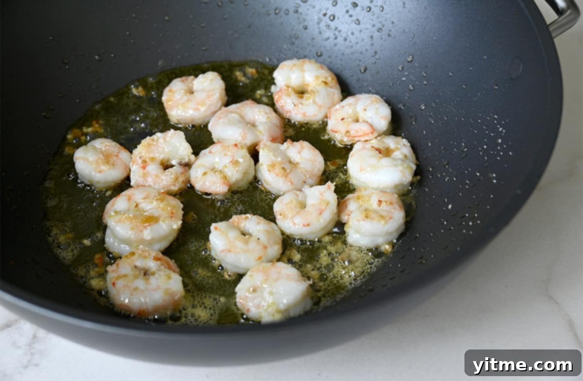 Sautéed shrimp in a wok.