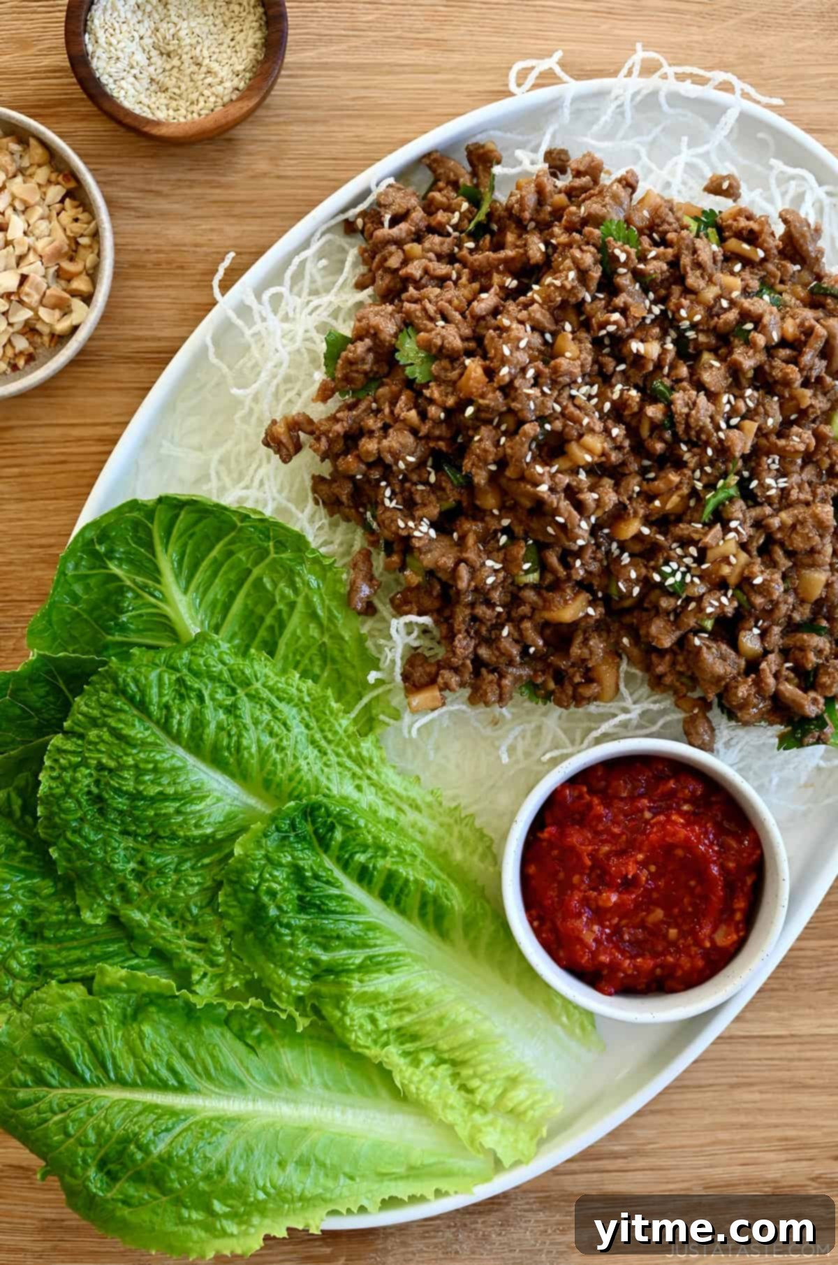 Chinese chicken lettuce wraps with ground chicken, rice noodles, and chili garlic sauce.