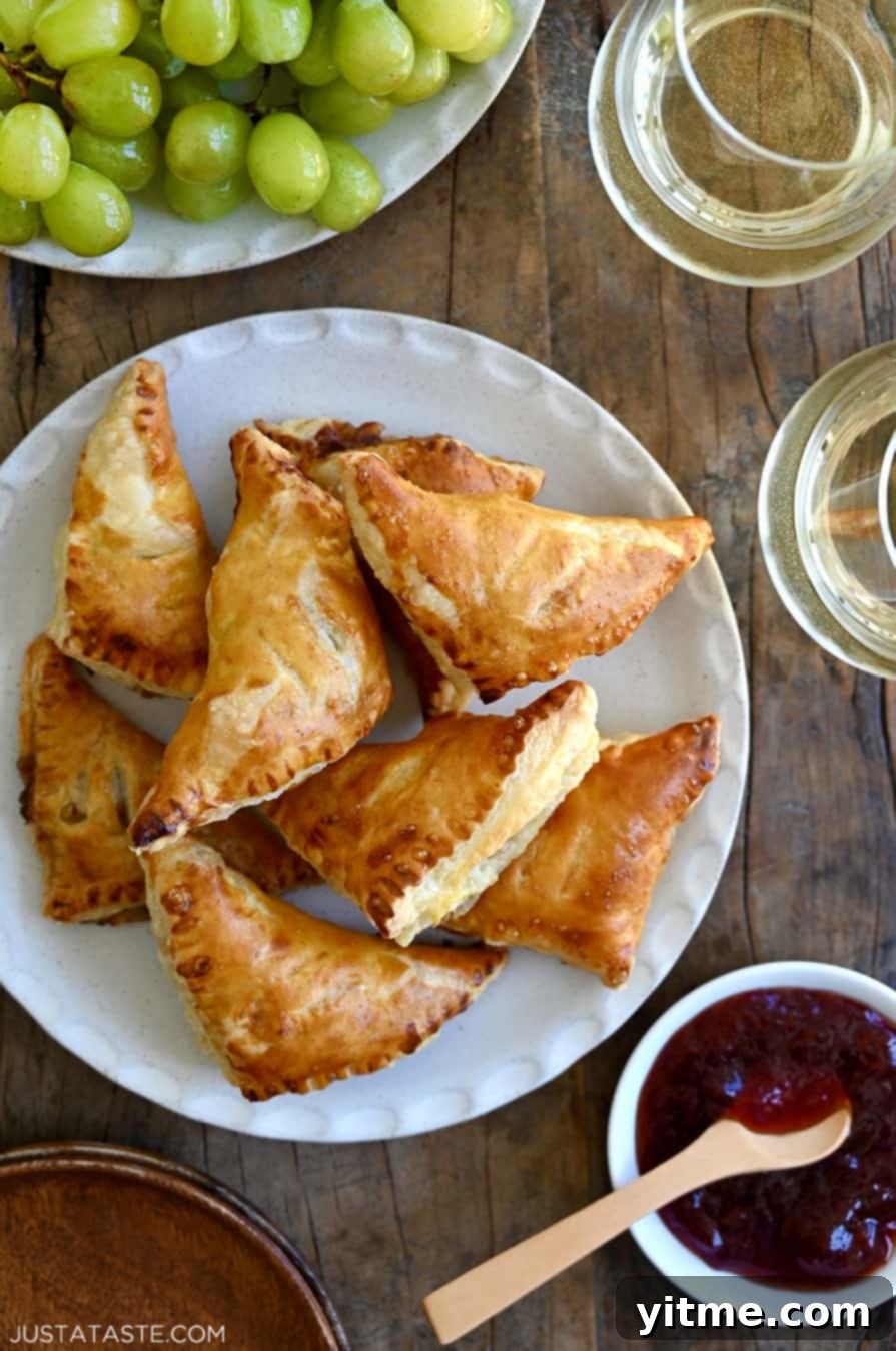 Baked Brie Bites with Jam piled on a plate with jam and wine