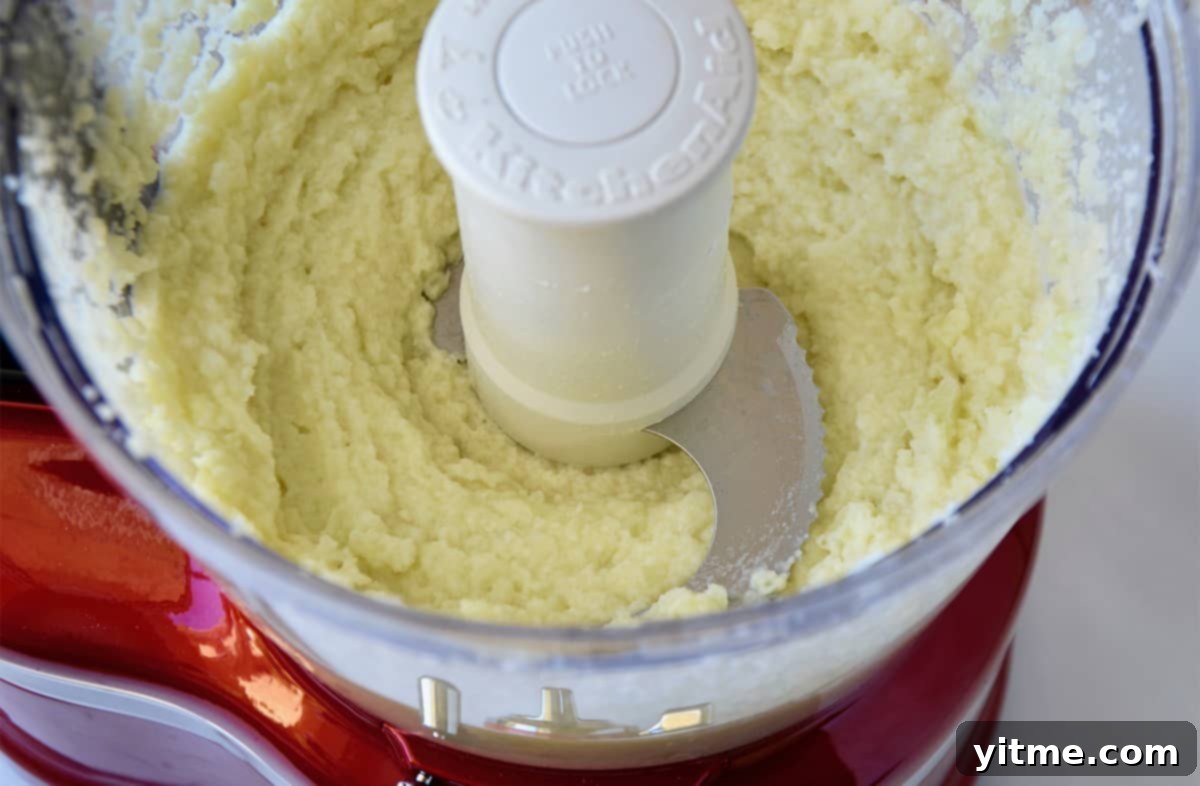 Cheesy Chive Mashed Cauliflower 6 Pureed cauliflower in the bowl of a food processor.