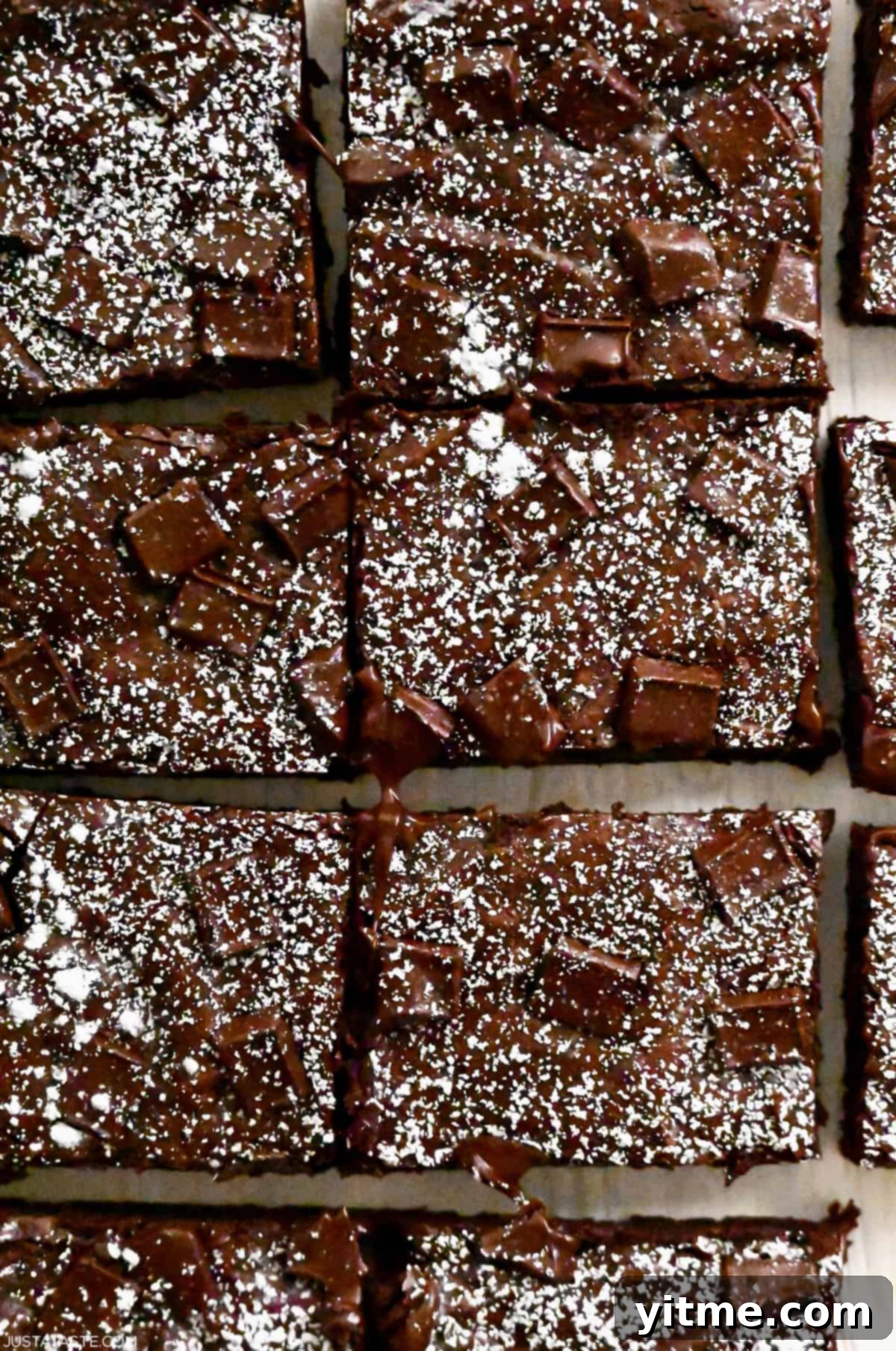 Brownies cut into perfect rectangles and dusted with powdered sugar.