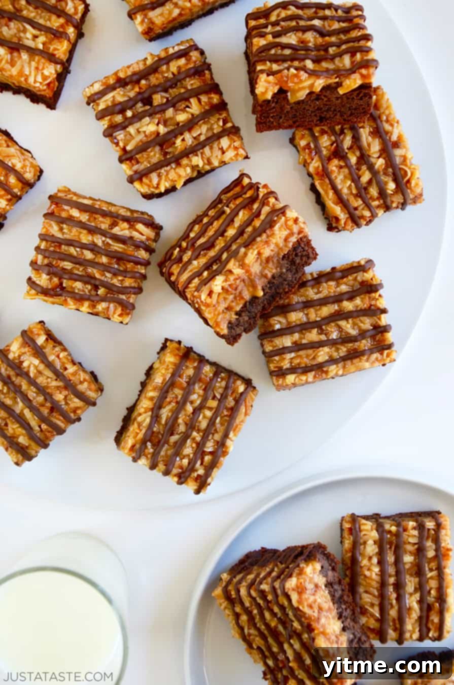 A top-down view of Samoas Coconut Caramel Brownies on a white serving plate.