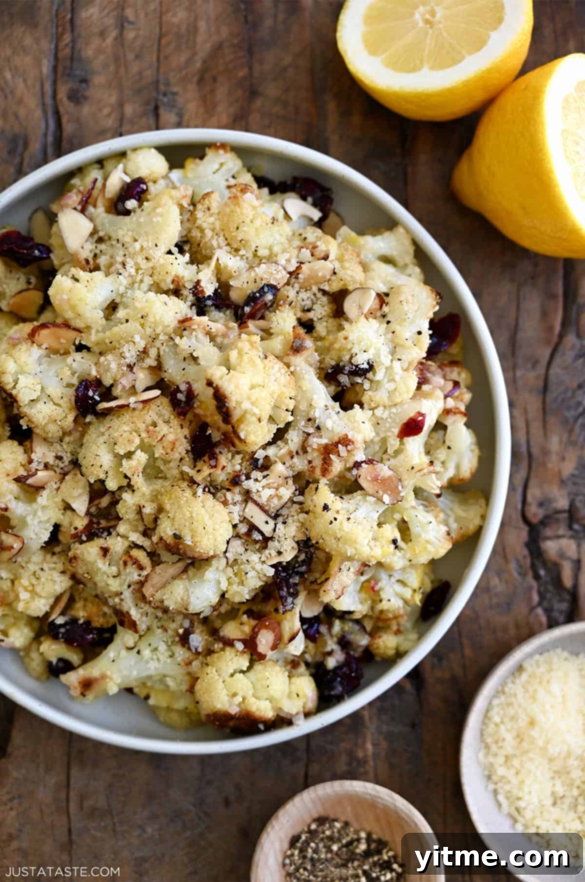 Close-up of roasted cauliflower salad with cranberries, almonds, and Parmesan.