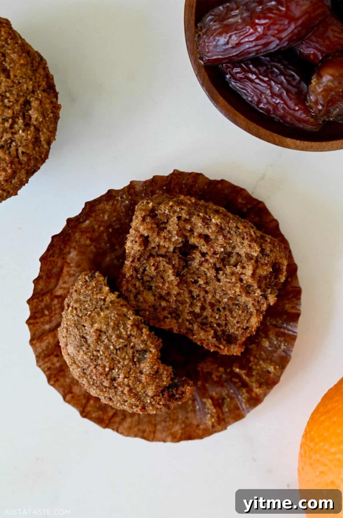 A moist bran muffin cut in half, revealing its soft texture and flecks of bran.