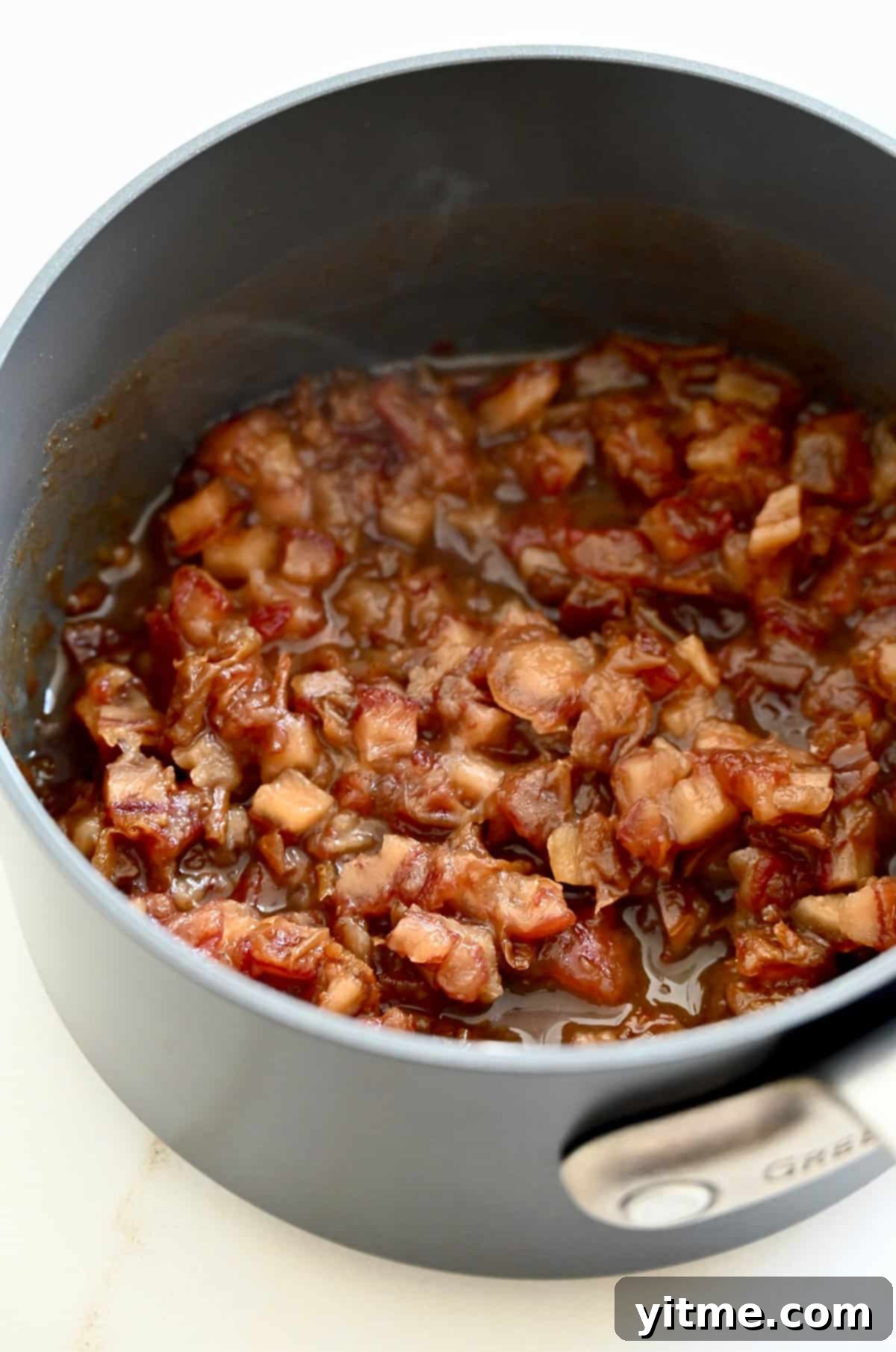 Soaked dates simmering in a saucepan.