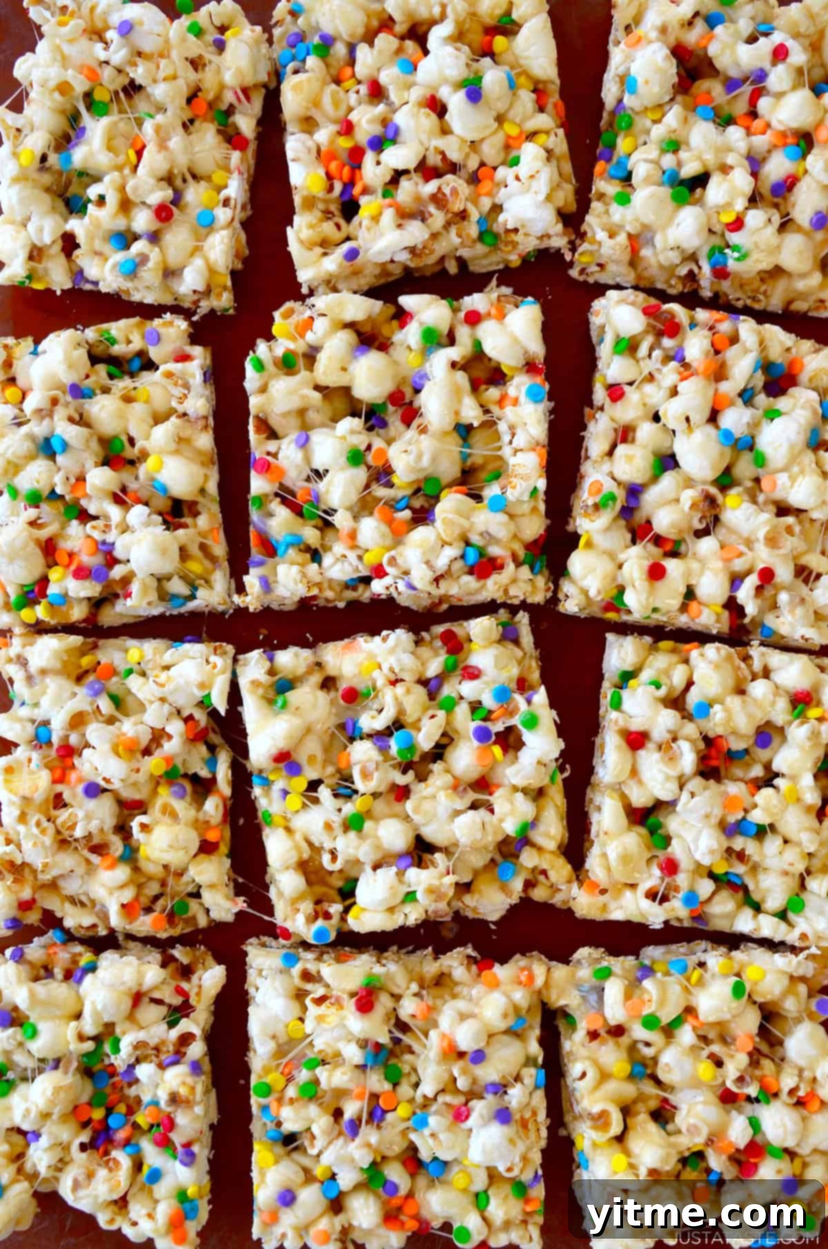 Squares of Funfetti Marshmallow Popcorn Treats.