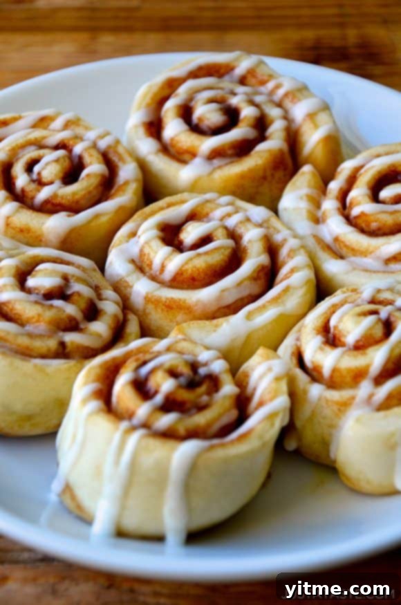 Pizza Dough Cinnamon Rolls with glaze on serving plate.