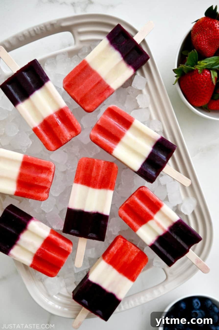 A white platter topped with crushed ice and vibrant red, white and blue popsicles, perfect for cooling down on a hot day.