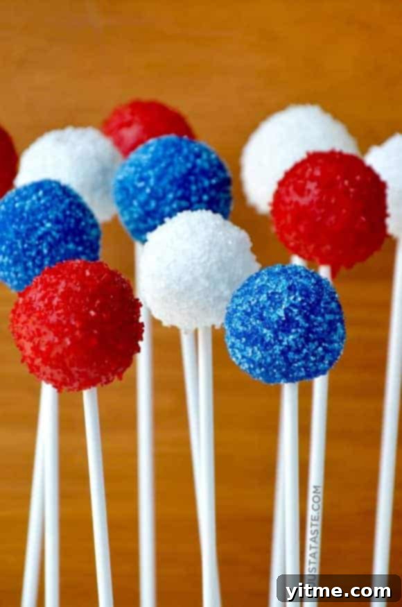 Red, White and Blue Oreo Cookie Pops, dipped in white chocolate and decorated with patriotic sprinkles.
