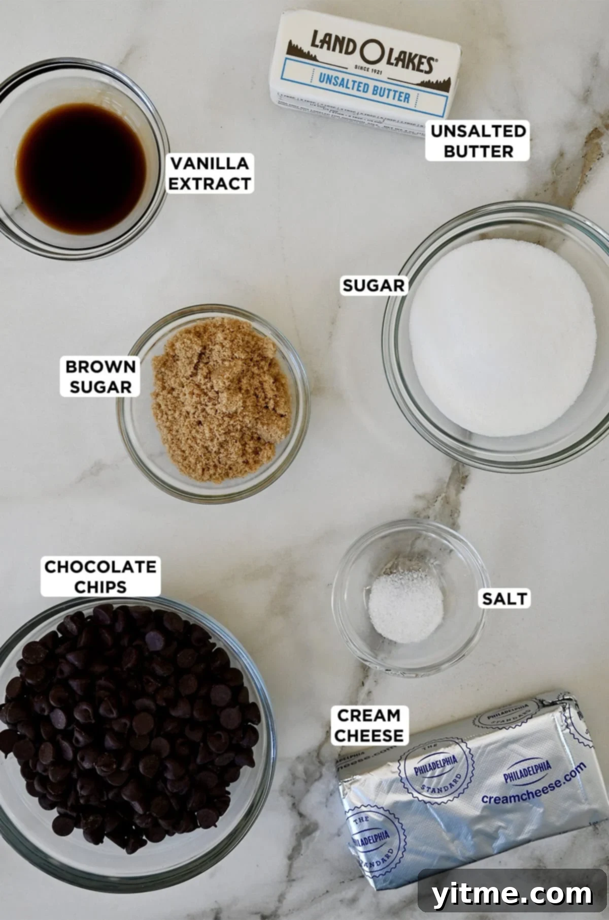 Chocolate Chip Cookie Dough Delight 3 Glass bowls containing ingredients for cookie dough dip, including vanilla extract, butter, sugar, salt, brown sugar, cream cheese and chocolate chips.