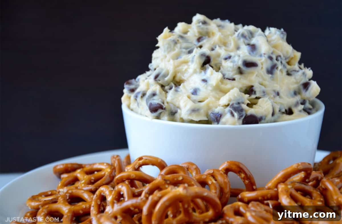 Chocolate Chip Cookie Dough Delight 6 Chocolate chip cookie dough dip in a bowl on a plate with salty pretzels.