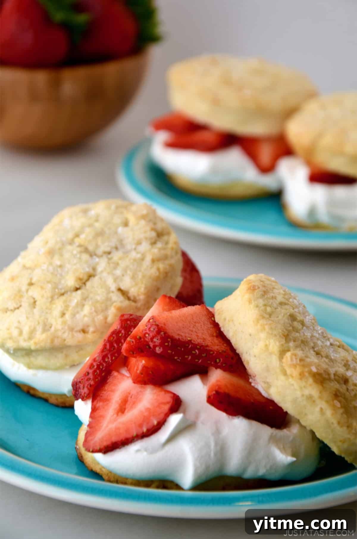 Strawberry shortcake with a generous dollop of stable homemade whipped cream, ready to be enjoyed.