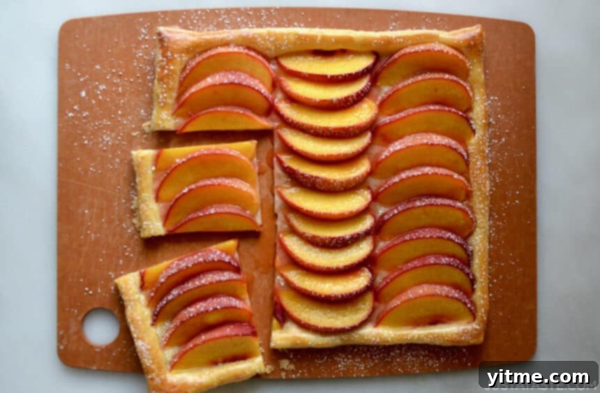 Top-down view of a delicious 5-Ingredient Peach Tart on a wooden cutting board.