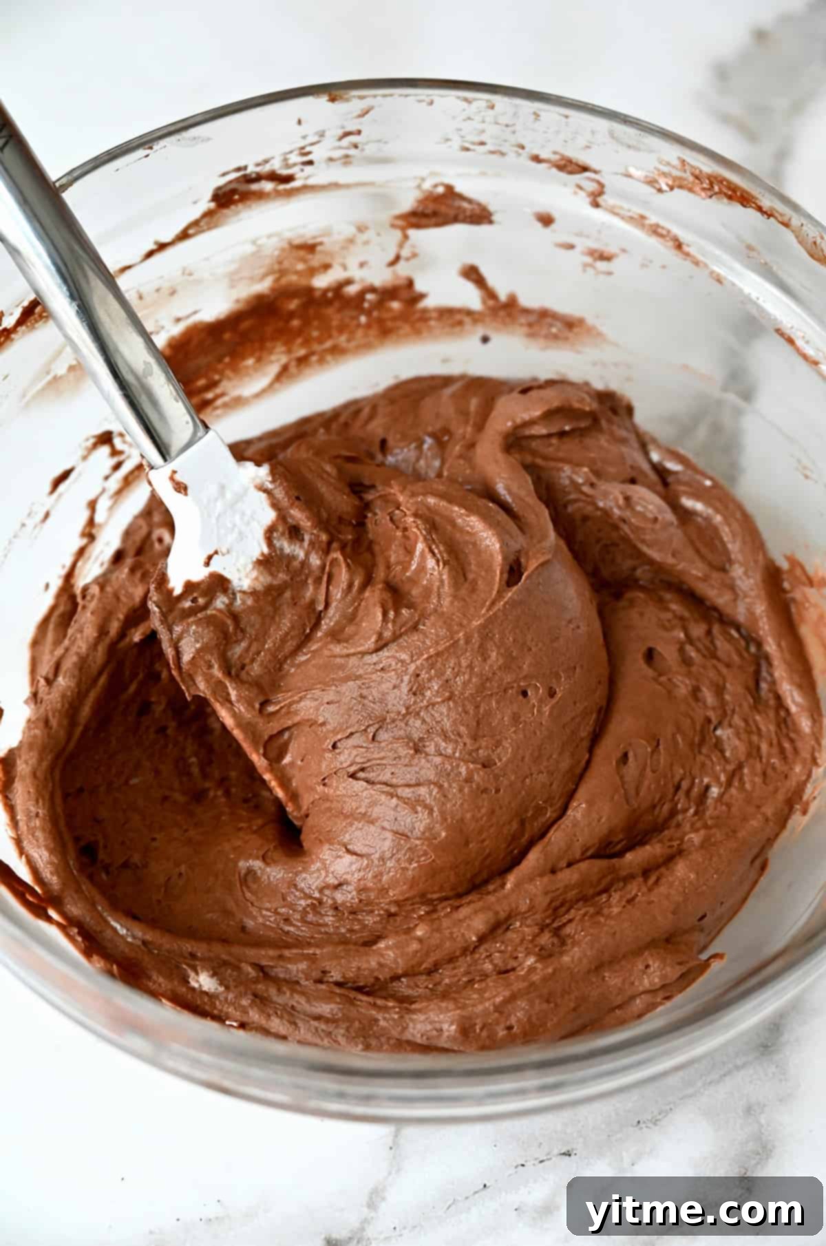 Chocolate mousse in a large glass mixing bowl.