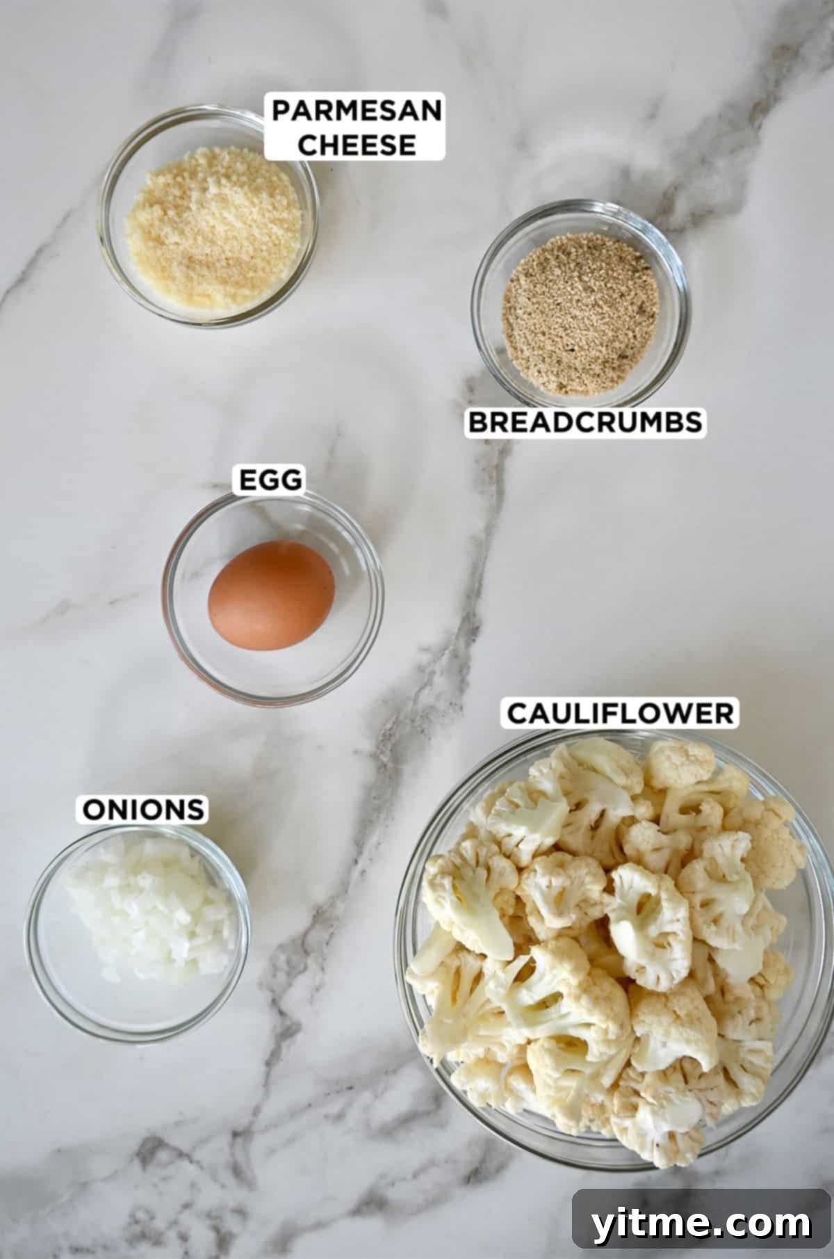 Cheesy Cauliflower Bites: 5 Ingredients, Endless Flavor 3 Ingredients for cauliflower tots: cauliflower, onion, parmesan cheese, breadcrumbs, and egg.