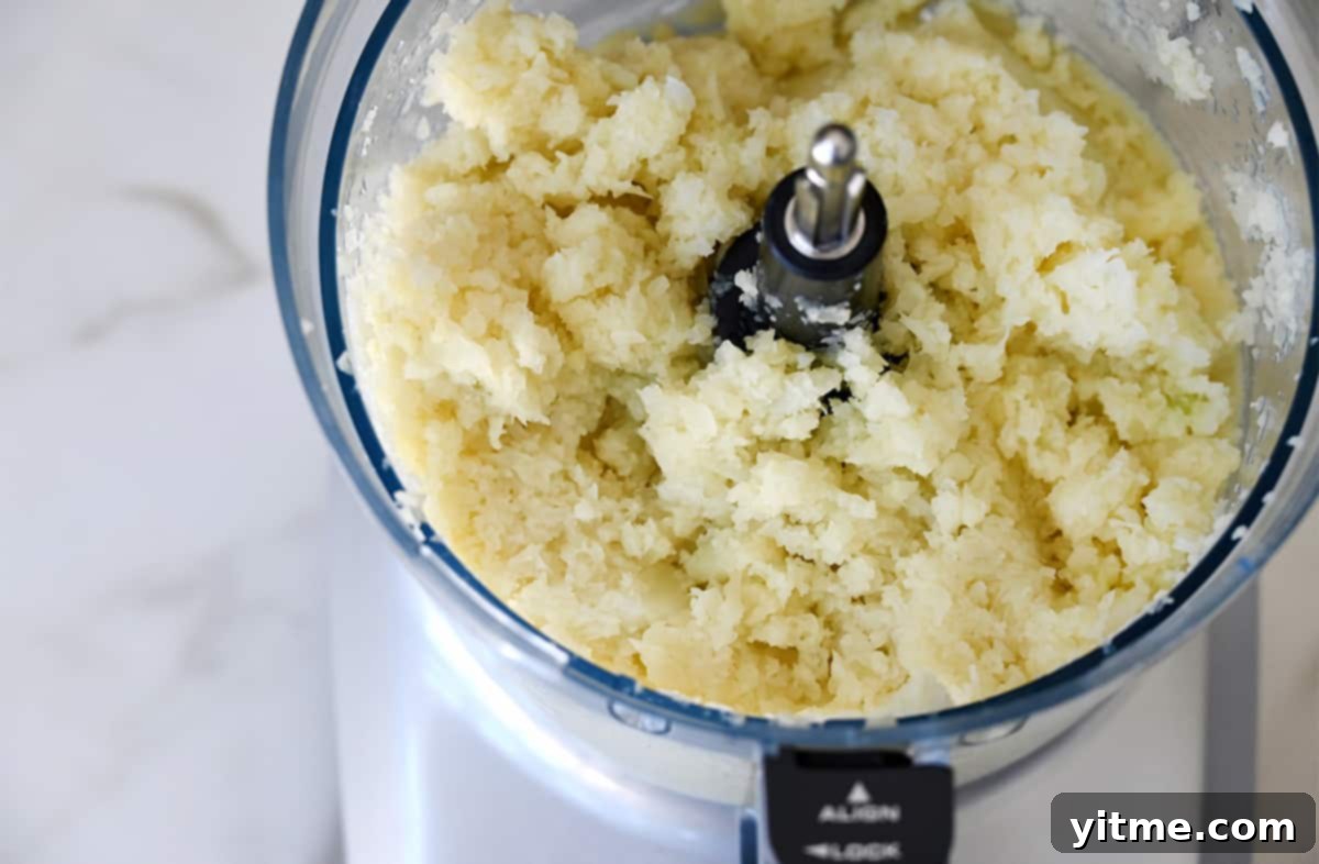 Cheesy Cauliflower Bites: 5 Ingredients, Endless Flavor 4 Pulsed cauliflower in a food processor.