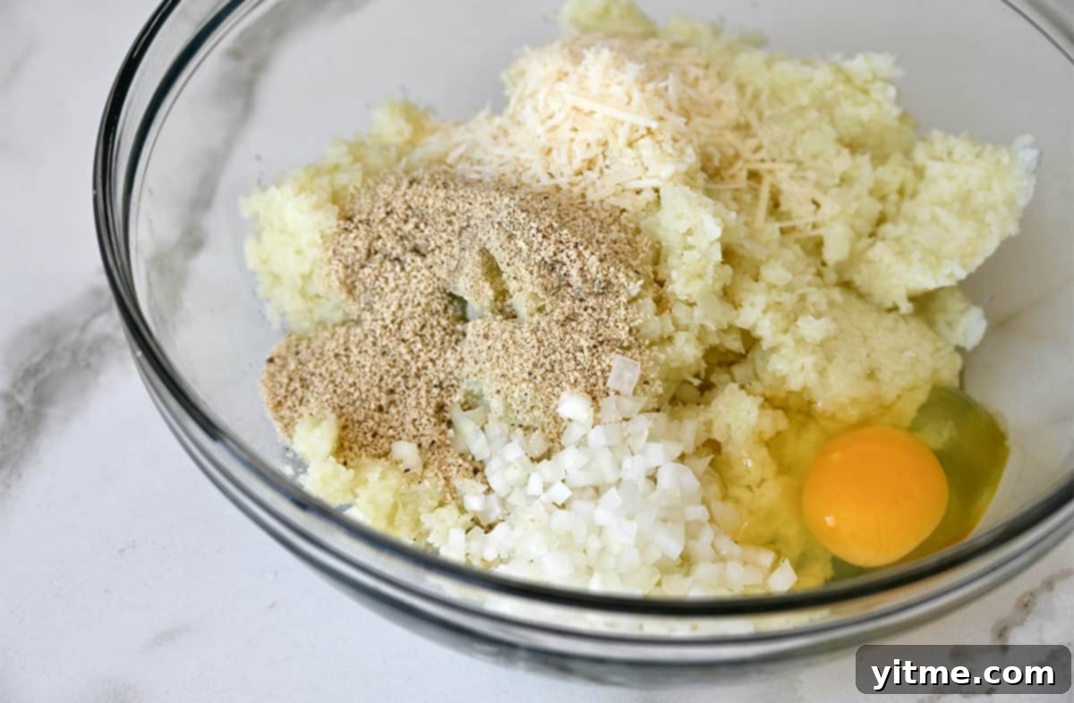 Cheesy Cauliflower Bites: 5 Ingredients, Endless Flavor 5 Cauliflower tot ingredients mixed in a bowl.