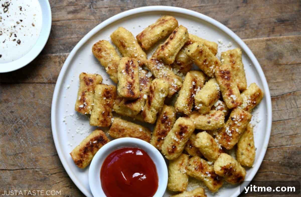 Cheesy Cauliflower Bites: 5 Ingredients, Endless Flavor 7 Cauliflower tots served with ketchup.