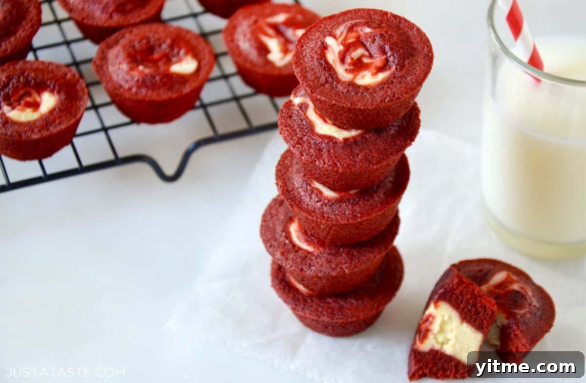 Red Velvet Cheesecake Brownie Bites stacked next to milk.