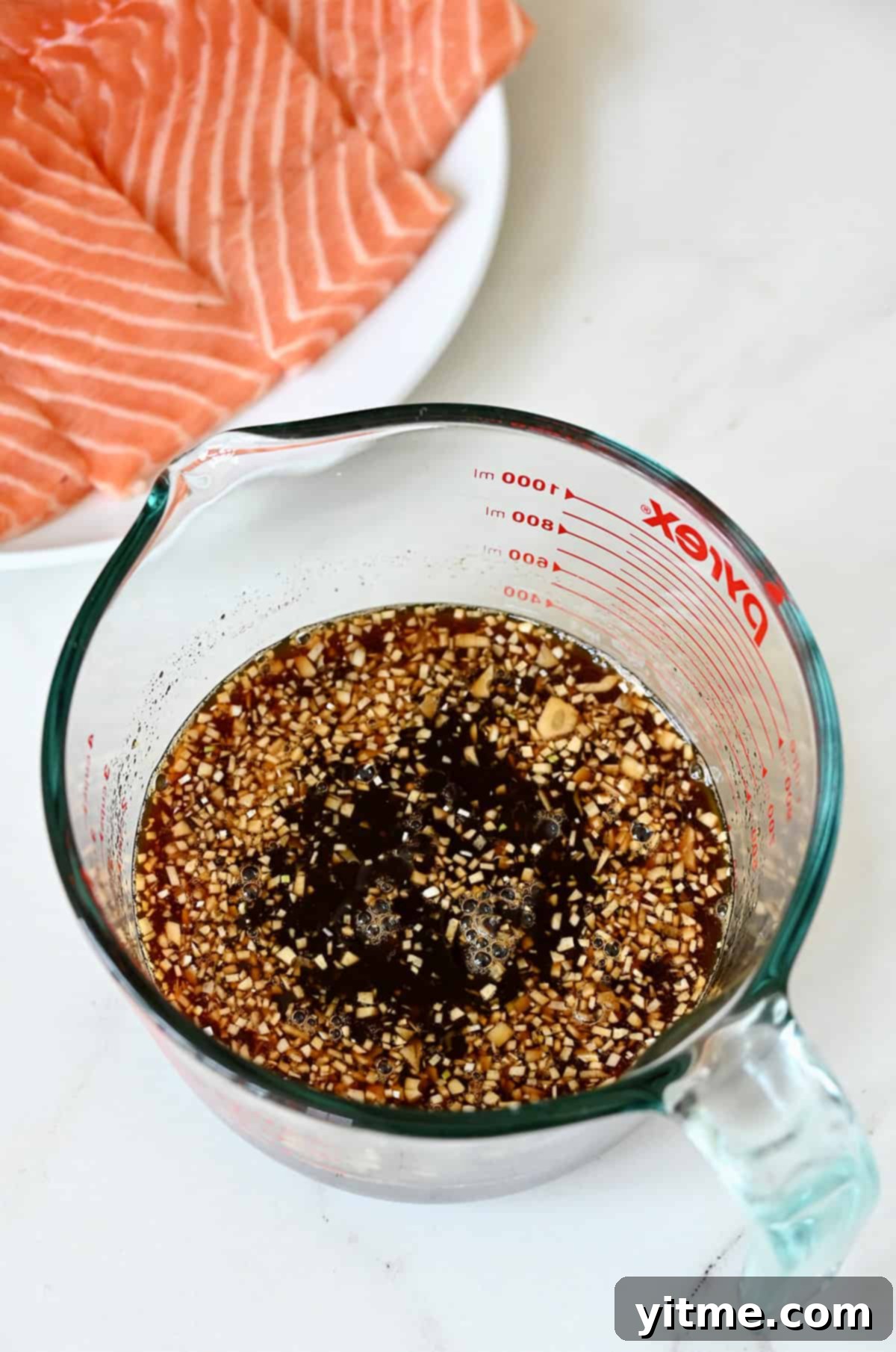 Honey-Garlic Glazed Salmon Delight 4 Honey garlic soy marinade in a liquid measuring cup.