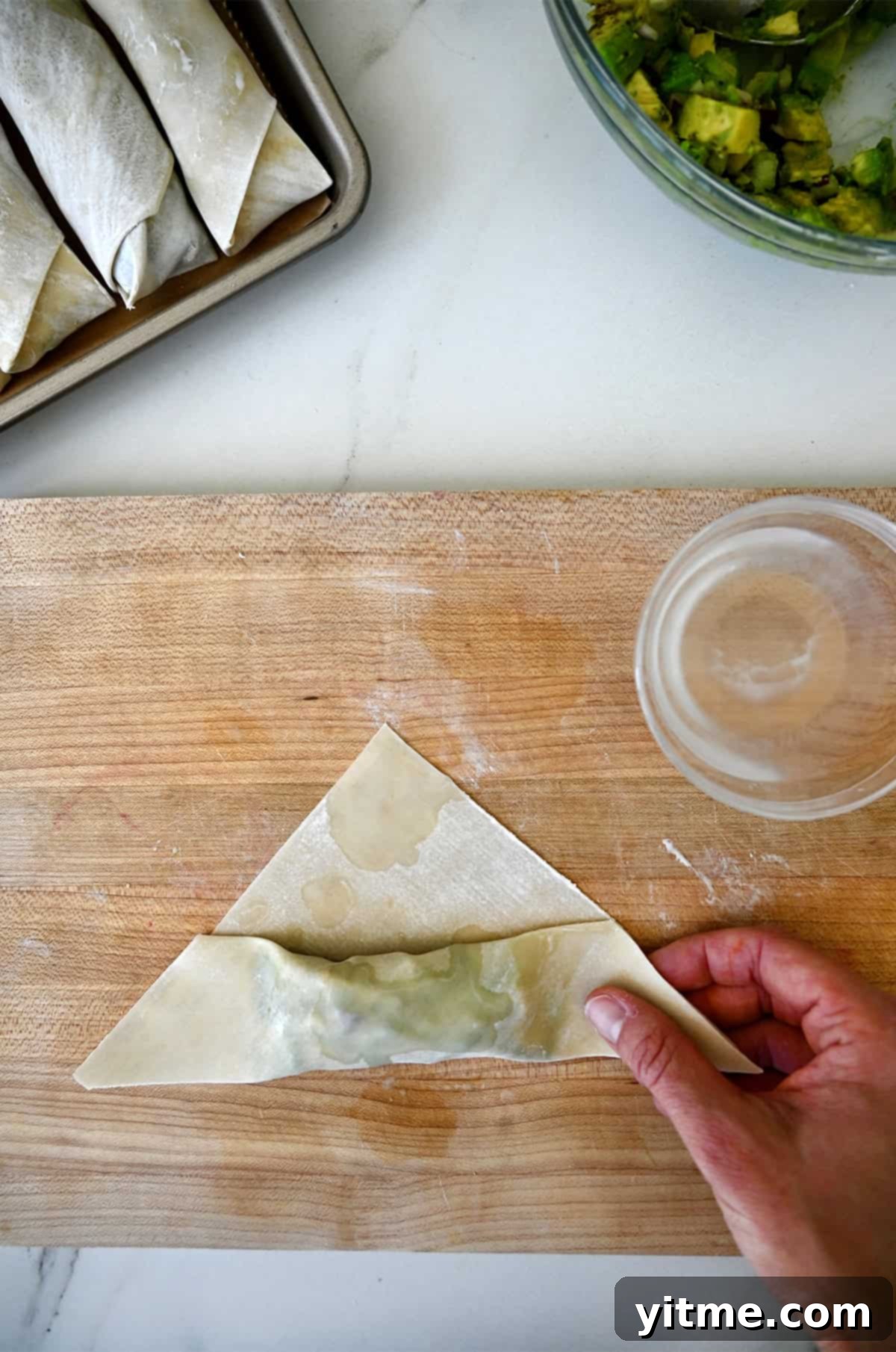 The second fold when making egg rolls just before folding in the corners.