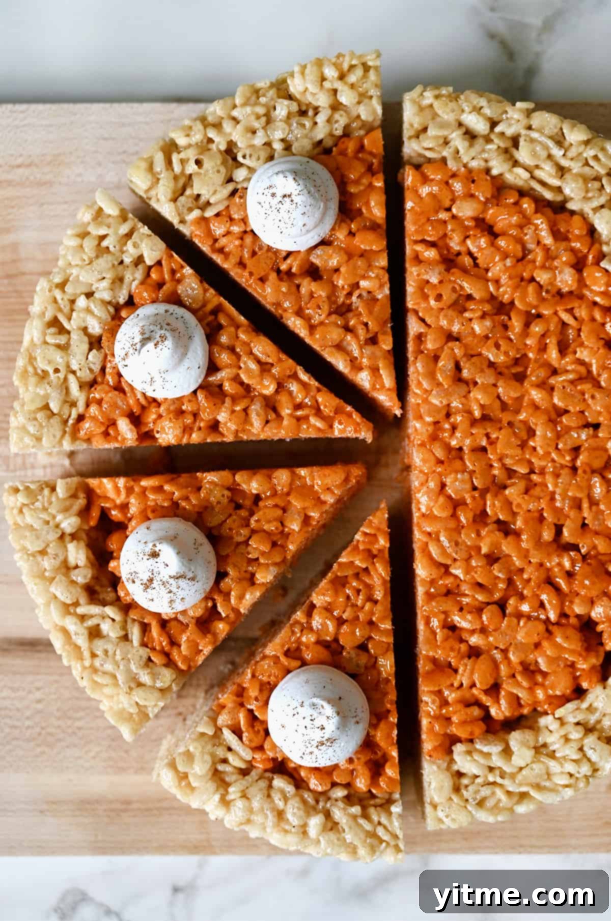 Pumpkin Spice Rice Krispies Delights 7 Pumpkin-flavored marshmallow treats topped with whipped cream and sliced into pie wedges.