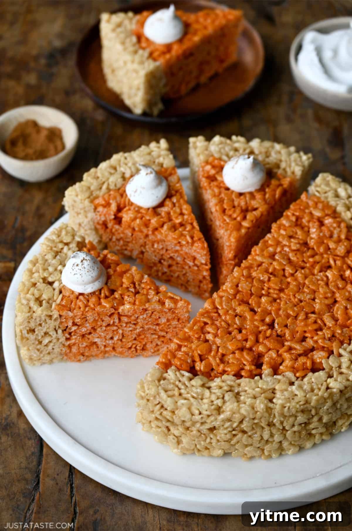 Pumpkin Spice Rice Krispies Delights 8 Pumpkin-flavored Rice Krispies treats cut into pie wedges and topped with whipped cream.