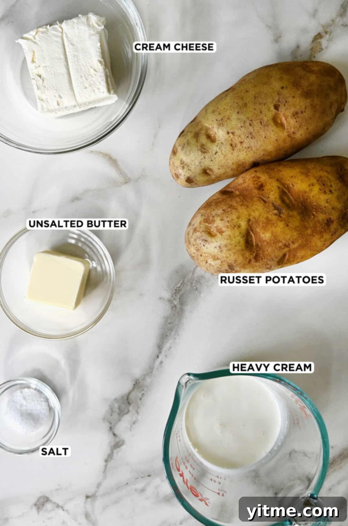 Ultimate Creamy Dream: The Mashed Potato Revelation 3 Two Russet potatoes next to various sizes of clear bowls containing cream cheese, butter, heavy cream and salt.