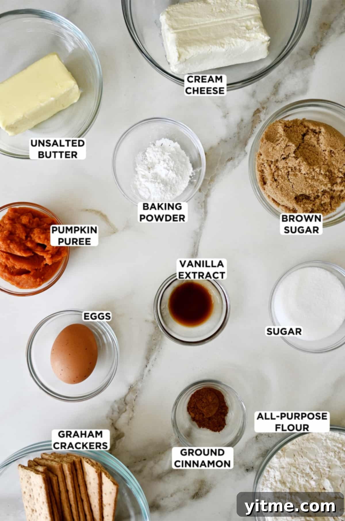 Ingredients for pumpkin cheesecake cookies: cream cheese, sugar, flour, spices, butter, pumpkin puree, egg, graham crackers.