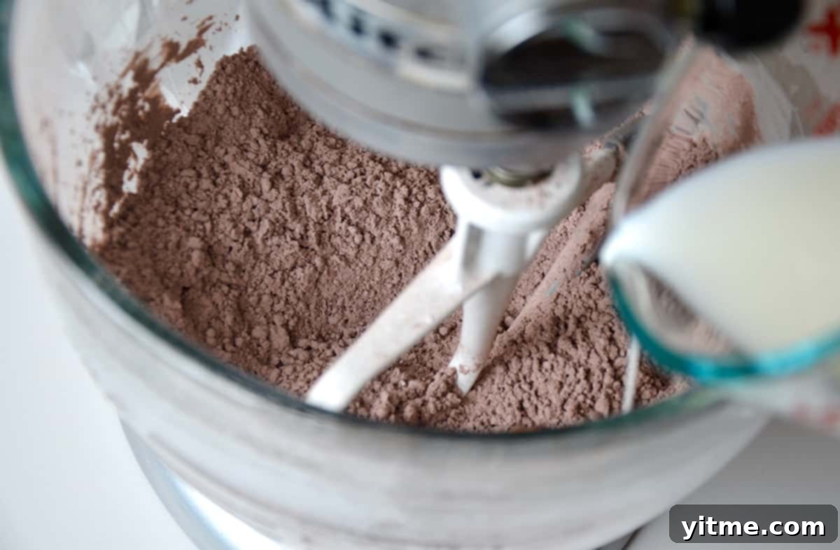 Milk being added to frosting ingredients