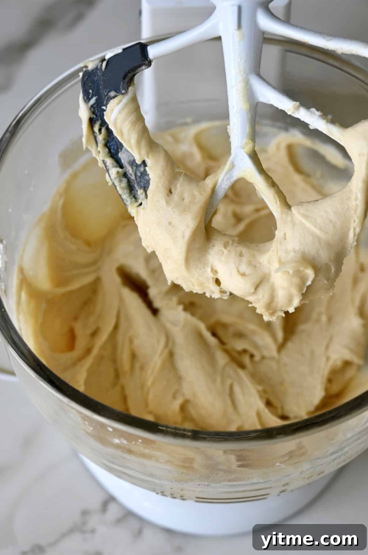 Coffee cake batter in a stand mixer bowl with the paddle attachment.