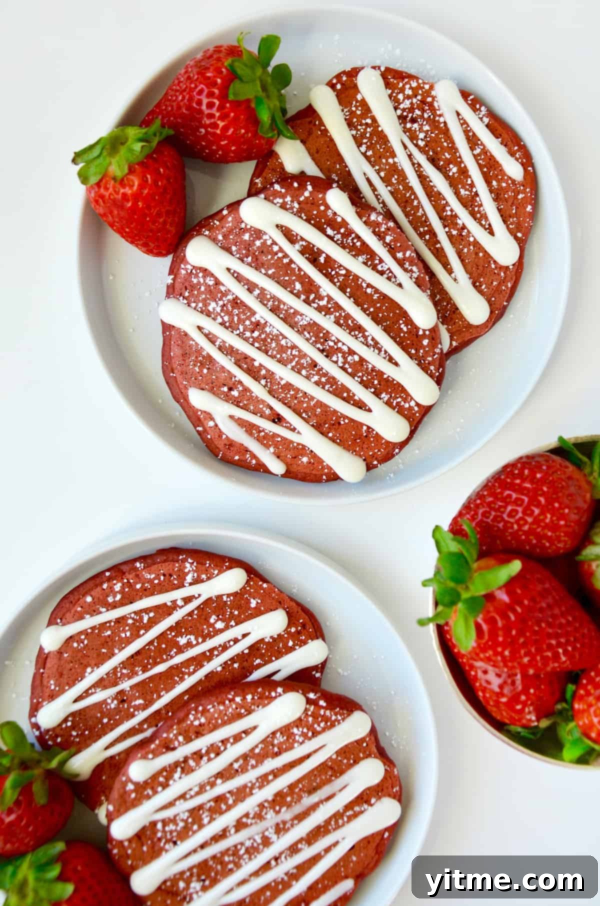 Red velvet pancakes with cream cheese glaze and strawberries