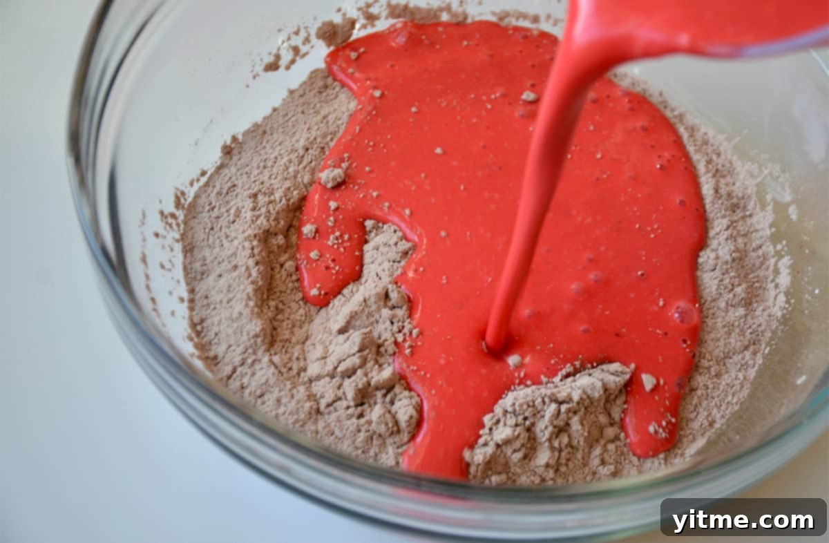 Wet ingredients being added to dry ingredients for pancake batter