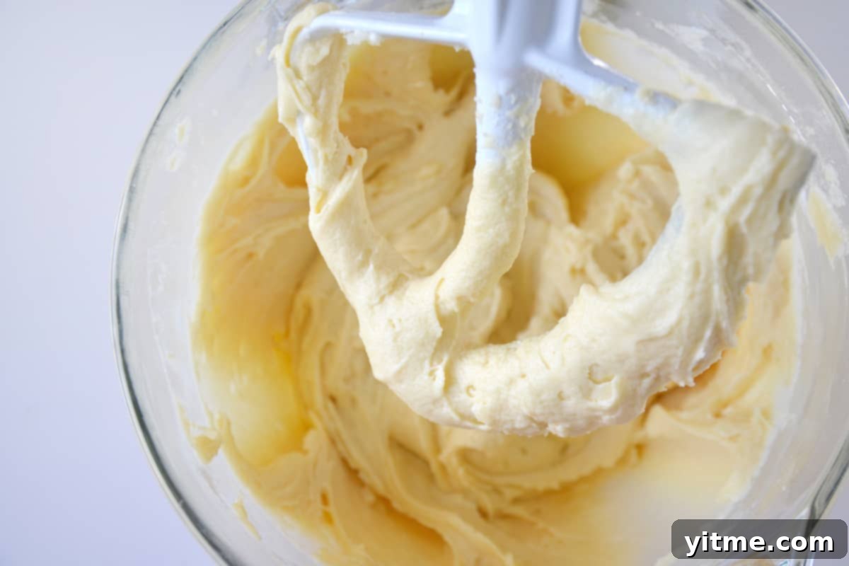 Yellow cupcake batter in a stand mixer bowl