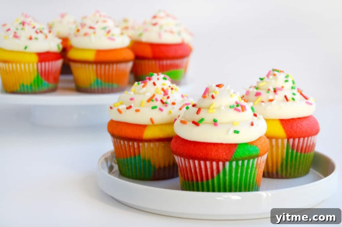 Rainbow cupcakes on white plates