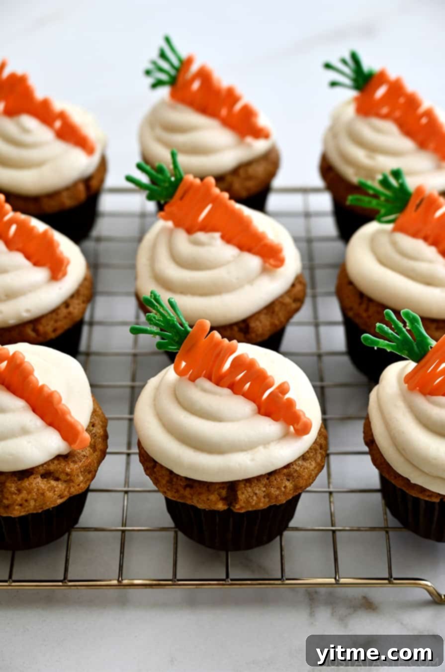 Carrot cupcakes with frosting and candy carrots