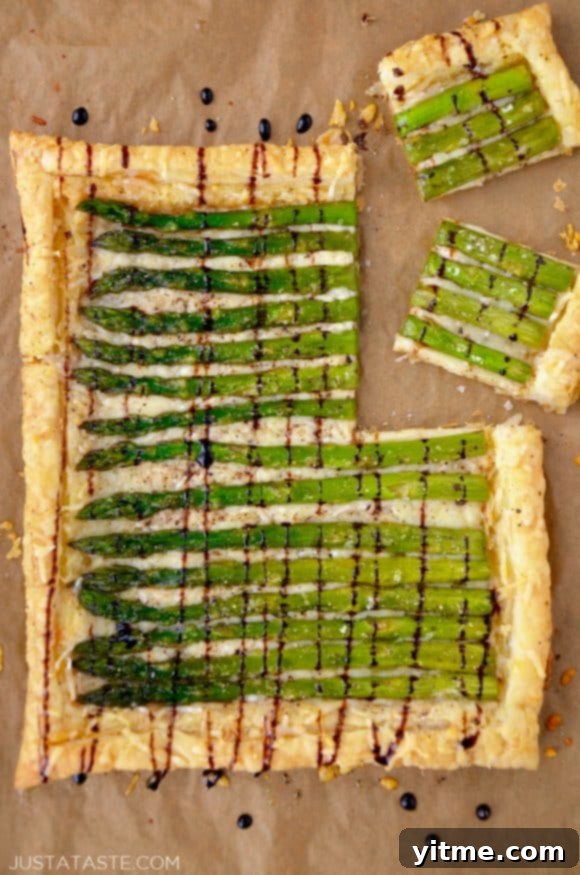 Cheesy Asparagus Tart drizzled with balsamic syrup on brown paper
