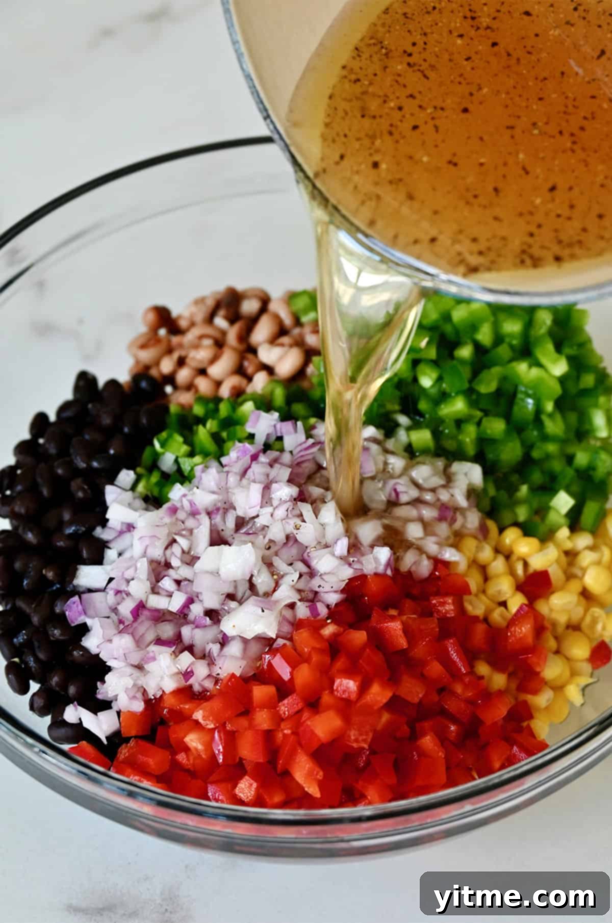 Dressing being poured over salad